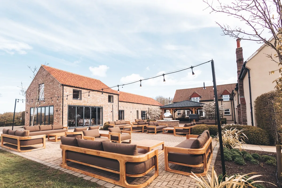 The barn with its bi-fold doors open onto the courtyard at The Hidden Oak.