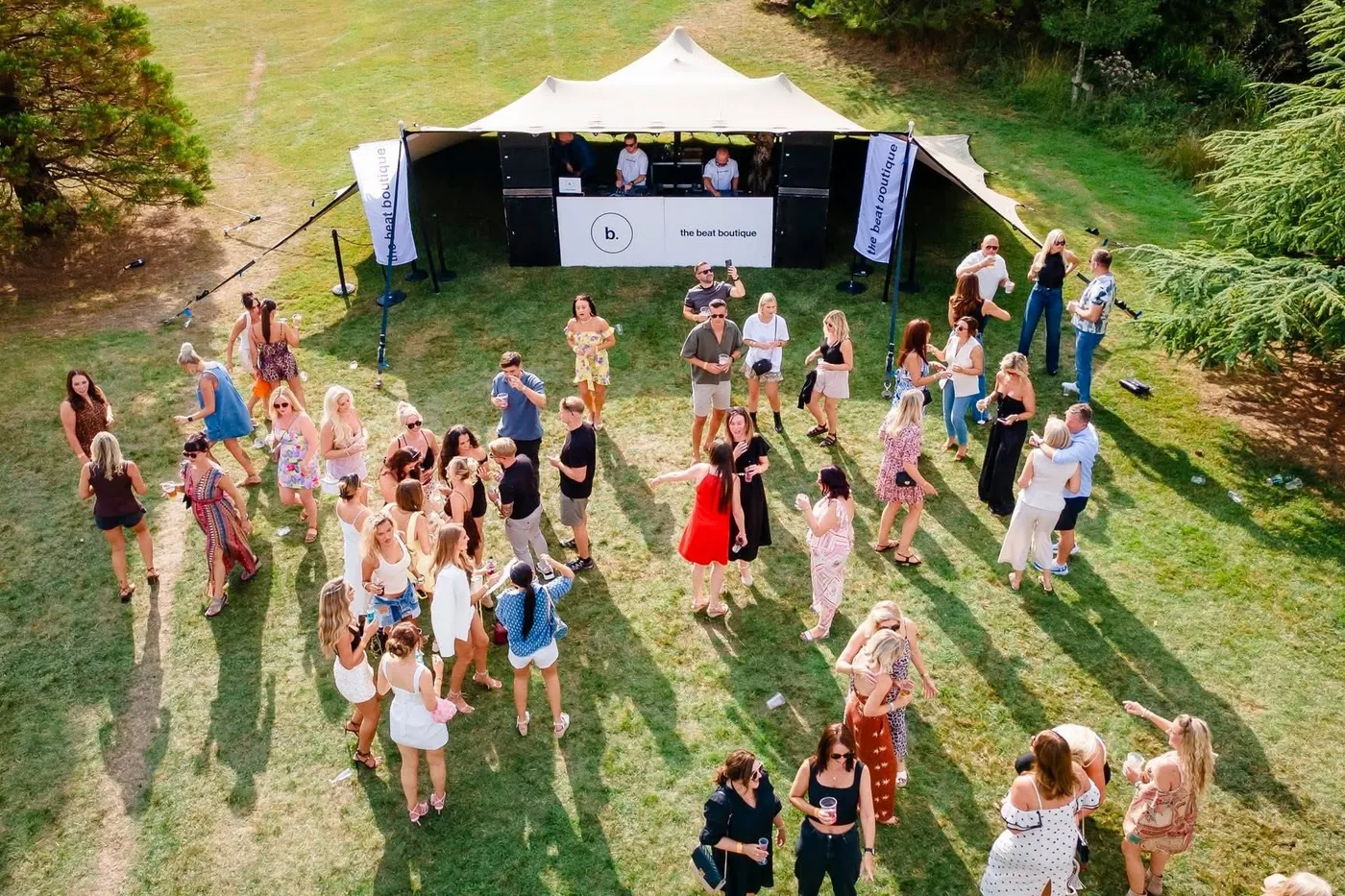 Guests dancing on the grass in front of the stage at The Garden Party.