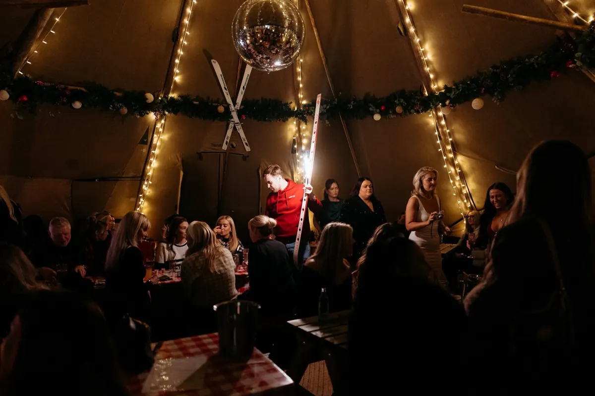 Inside the tipi at Après-Ski, disco ball and skis overhead.