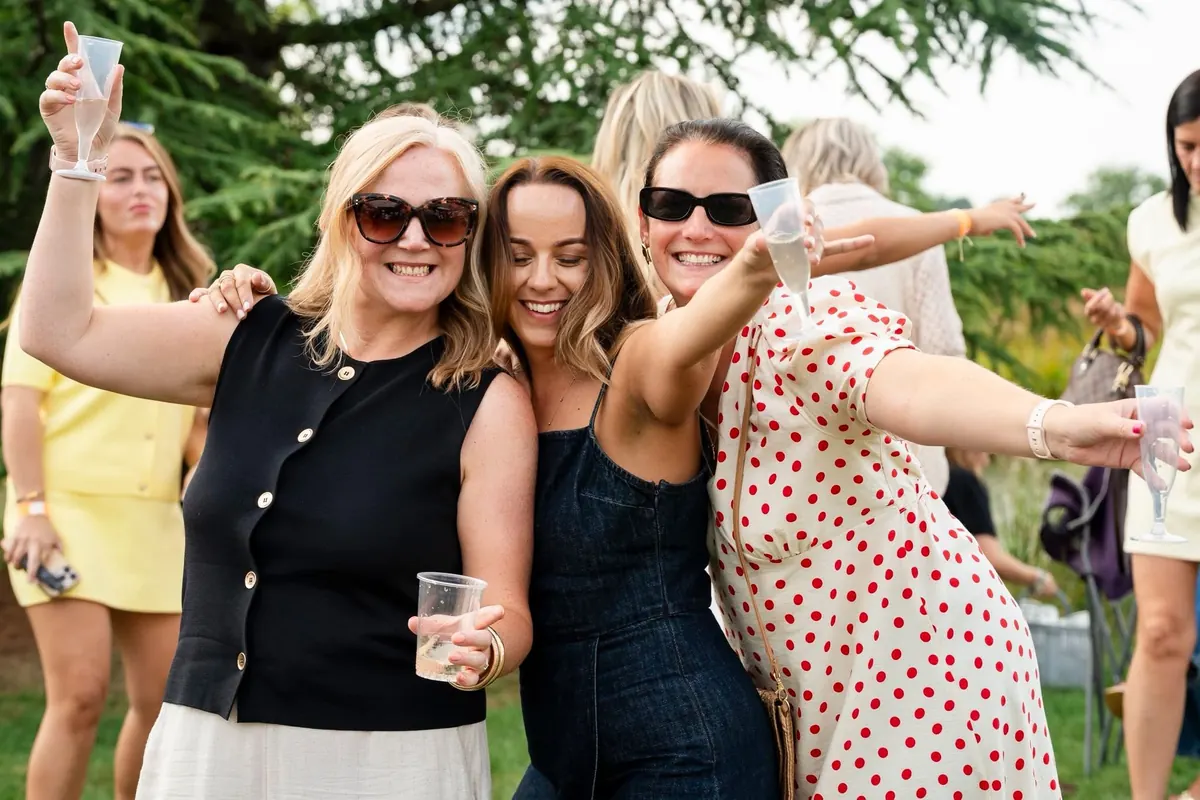 Friends raising a toast on the lawn