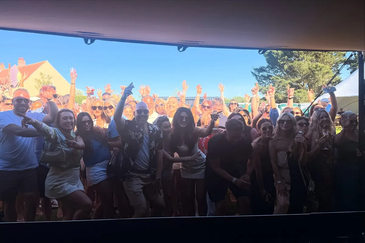 Hands in the air in front of the stage at The Garden Party.