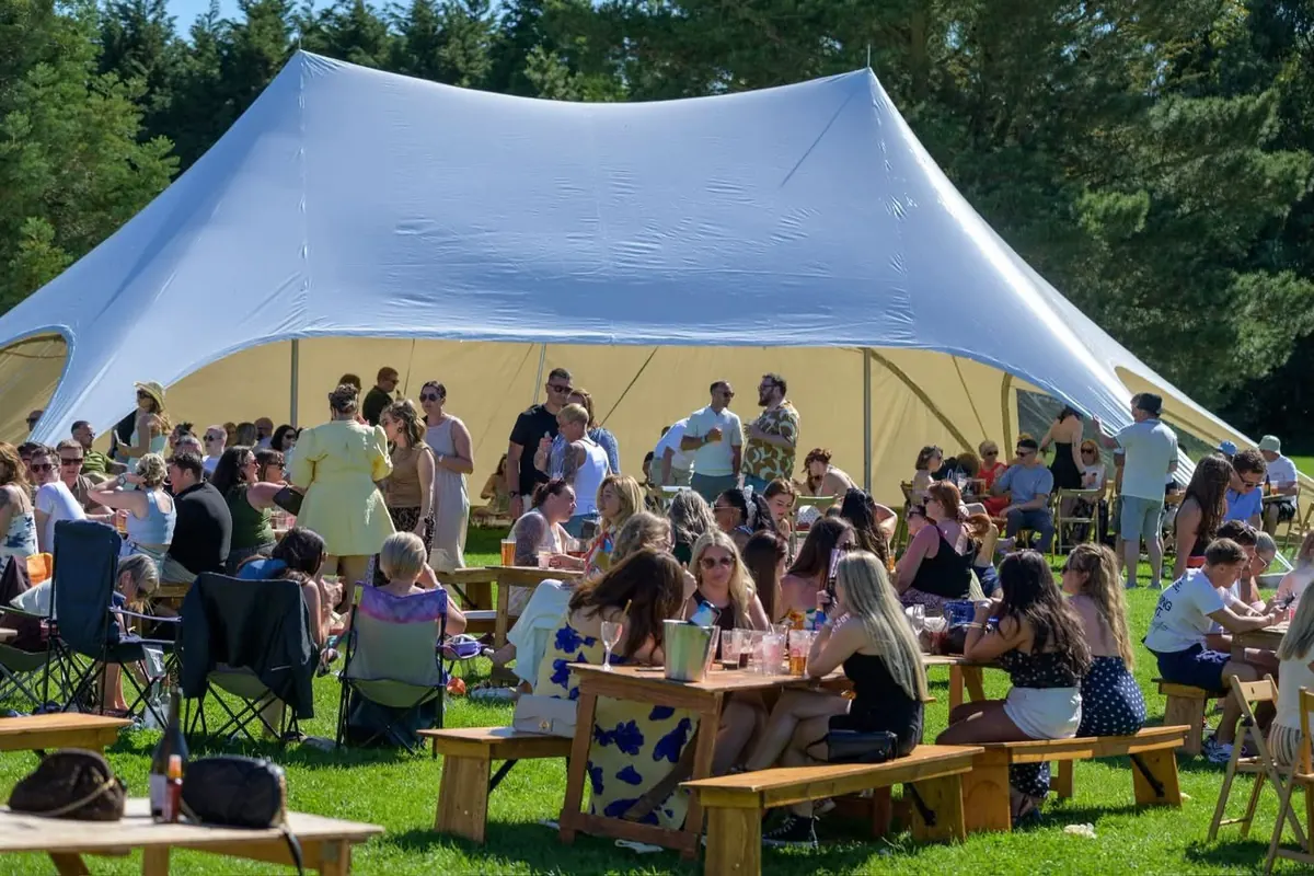 Guests gathered under the stretch tent