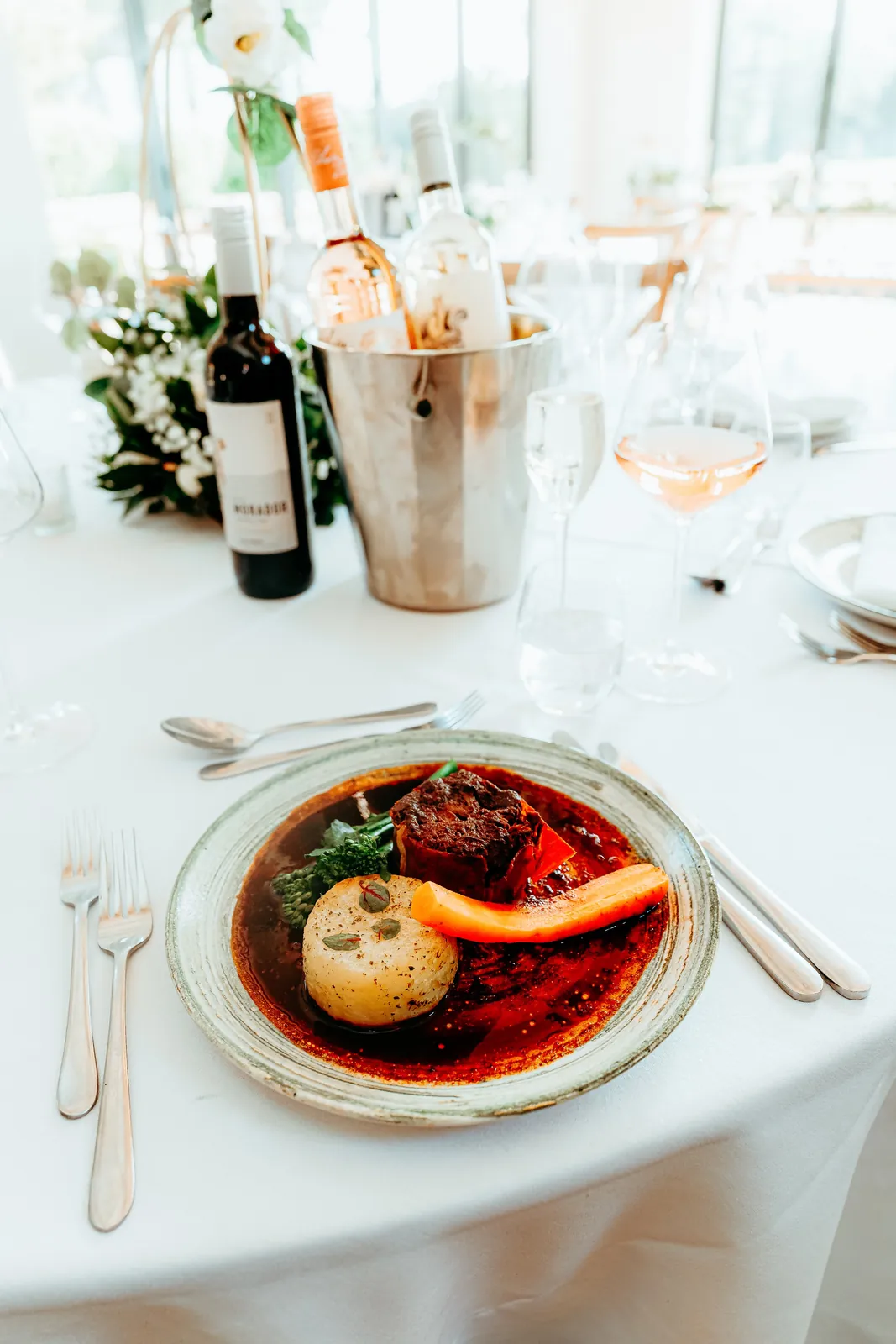 A table laid for the wedding breakfast, wine poured