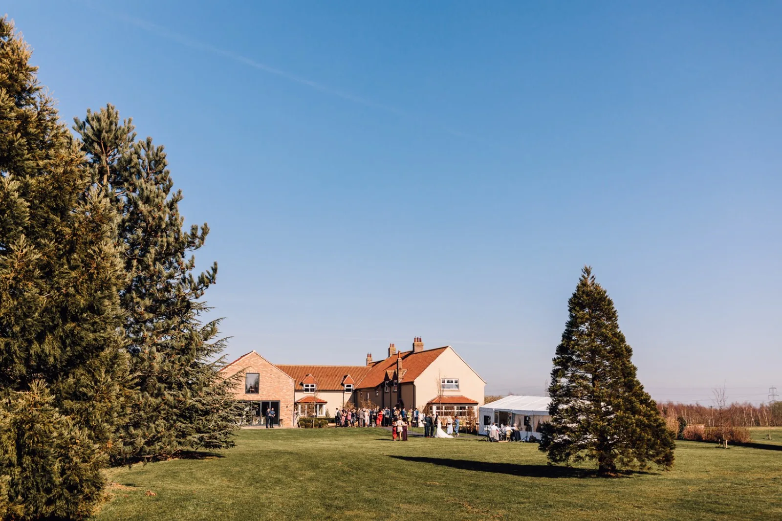 The Farmhouse and stretch tent across the lawn
