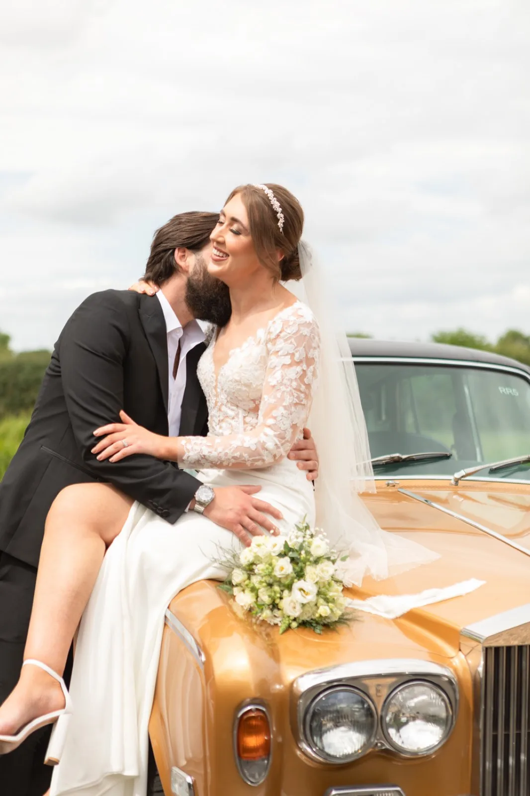A couple on the vintage wedding car