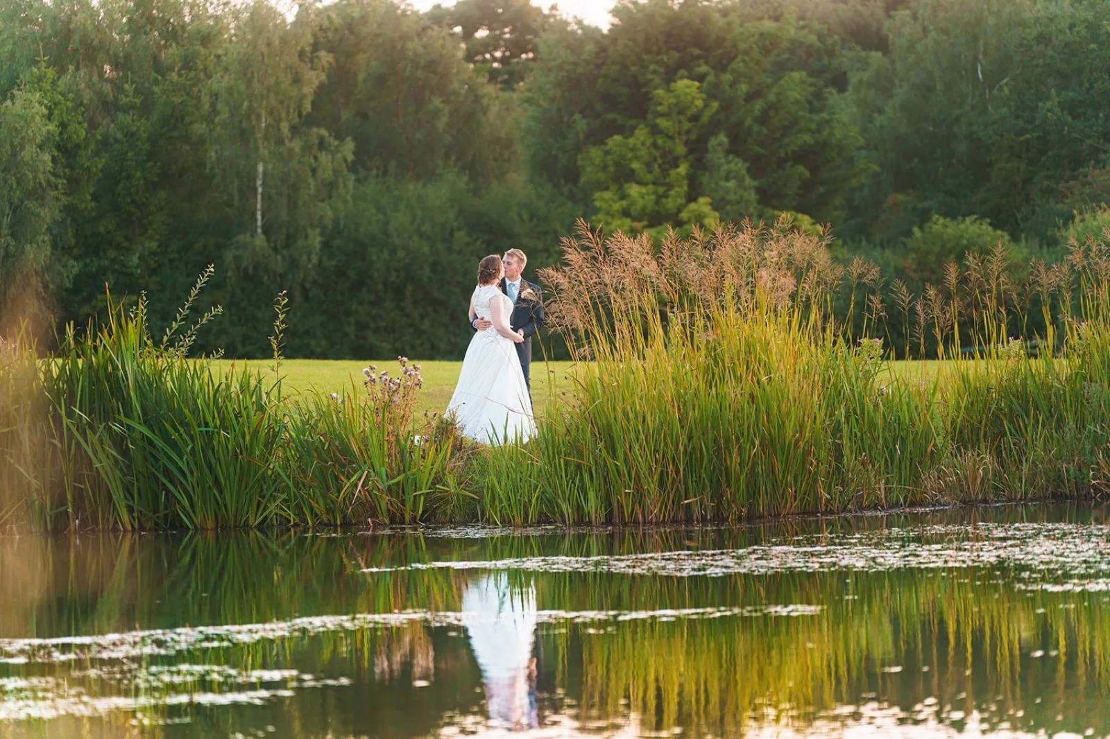 A couple by the lake, reflected in the water