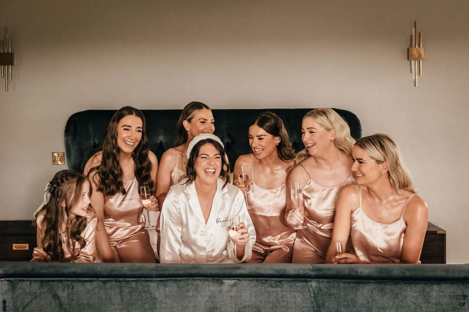Bridesmaids in their robes, mid-laugh