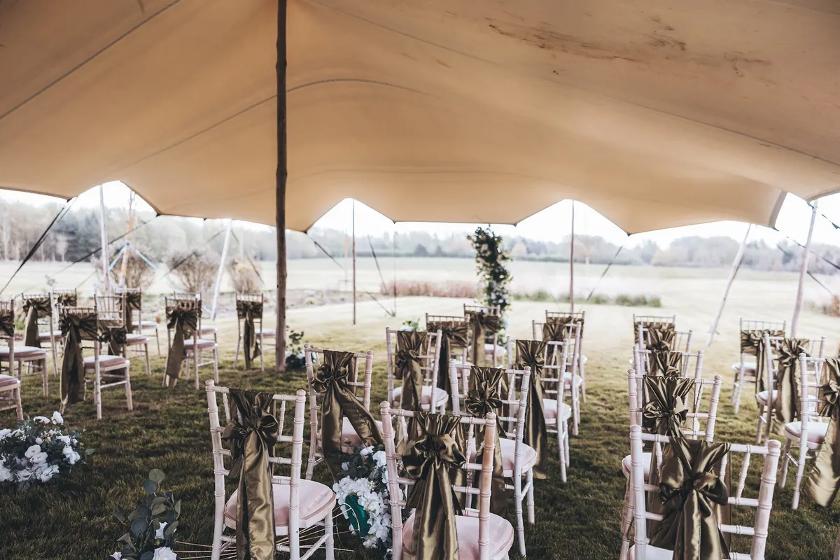 A ceremony set under the stretch tent in the secret garden.