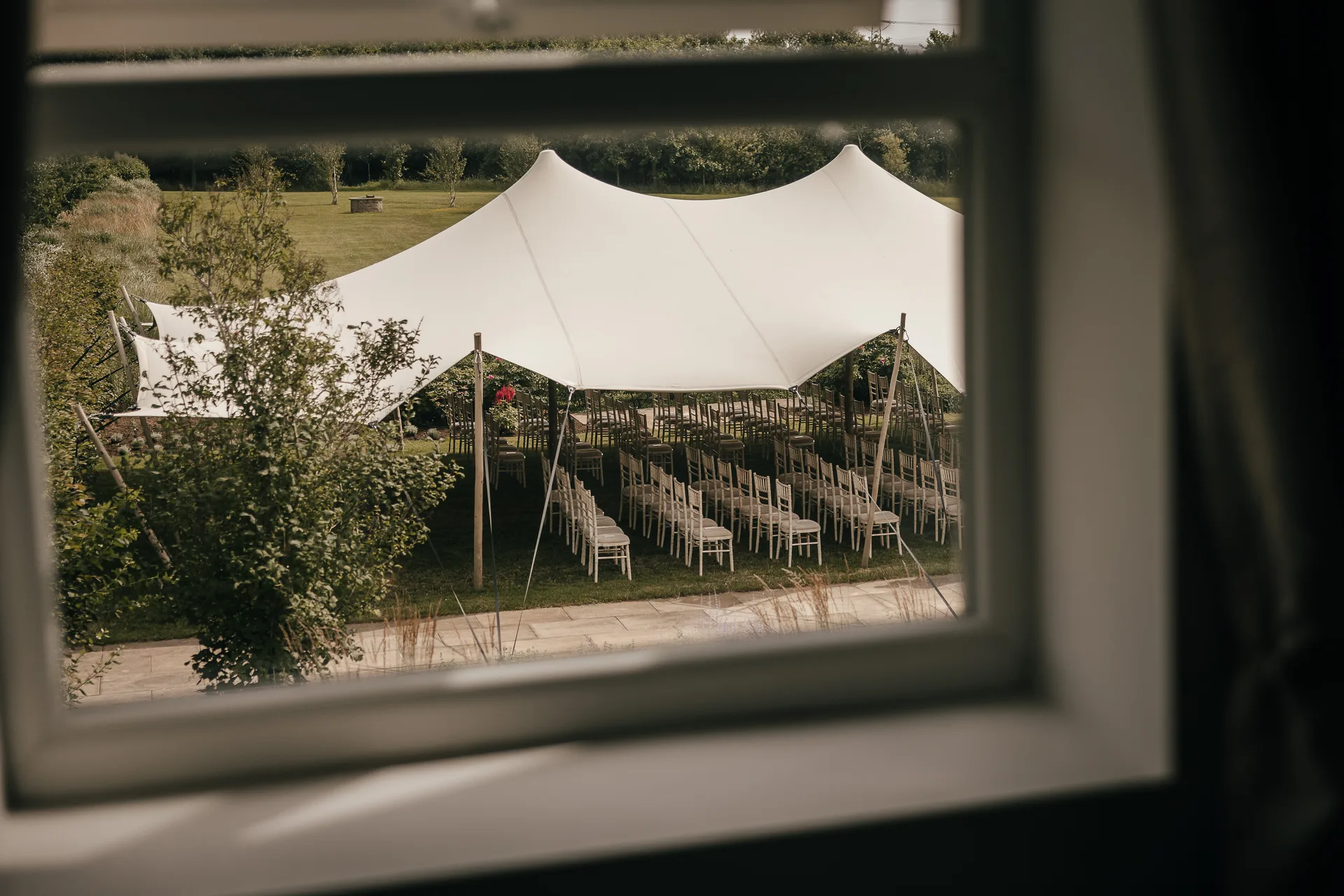 The stretch tent set for a ceremony, seen from a window of the Farmhouse.