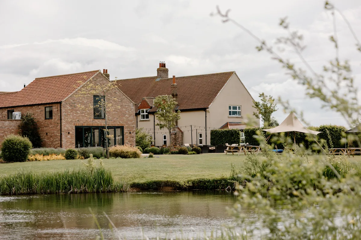 The Farmhouse and Barn seen across the lake at The Hidden Oak.